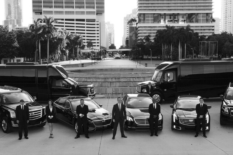 A professional Transportation Company showcasing a fleet of luxury buses, vans, and SUVs with uniformed drivers in an urban city setting